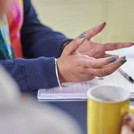 Close-up image of woman's hands explaining something