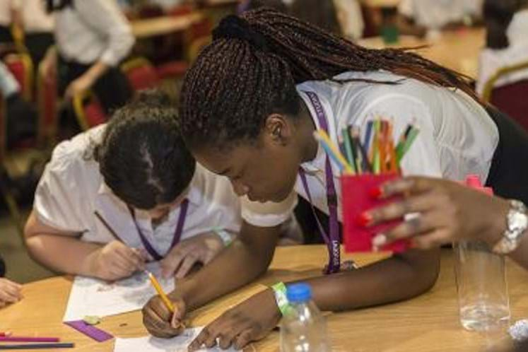 Two children drawing their selfie artwork