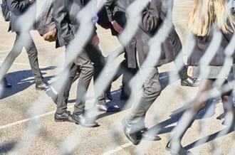 Secondary school students walking in a playground