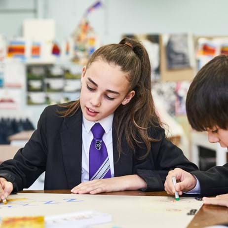 Two young people colouring